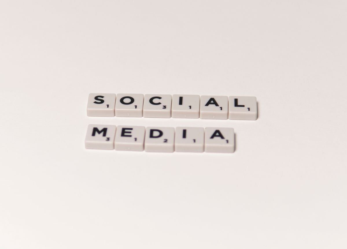 Scrabble tiles spelling social media, representing X Twitter banner design concepts